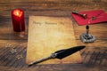 Classic Valentine`s Day cad with decorative quill and stand, red envelop with wax seal, red candle, wooden de, space for your text